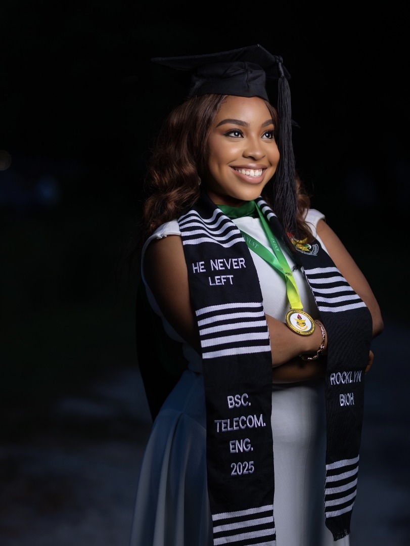 A graduate wearing the Monochrome sash, embroidered with her degree and a custom logo.